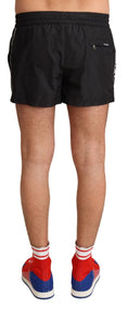 Load image into Gallery viewer, Dolce & Gabbana Elegant black KING motif swimming trunks
