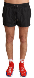 Load image into Gallery viewer, Dolce & Gabbana Elegant black KING motif swimming trunks
