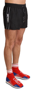 Load image into Gallery viewer, Dolce & Gabbana Elegant black KING motif swimming trunks
